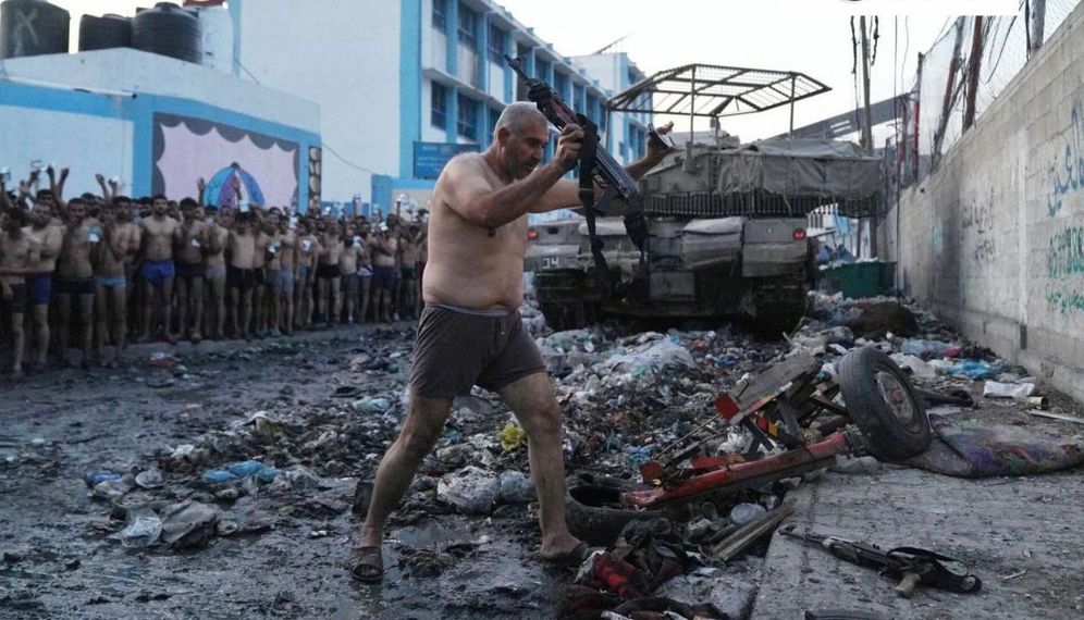 A Hamas jihadist in the Gaza Strip surrendering his weapon