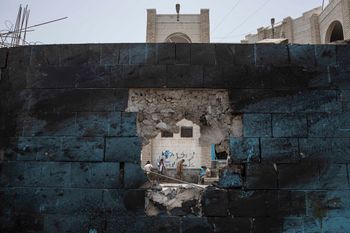 Soldiers guard the site of a deadly attack inside the Sheikh Othman police station in Aden, Yemen.