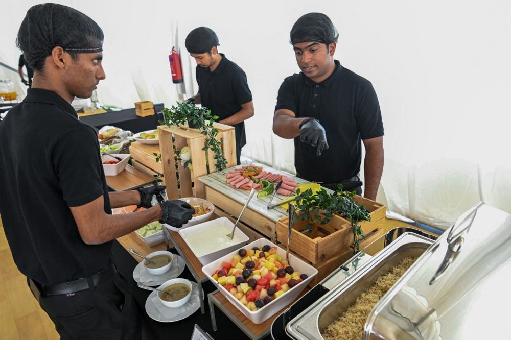 Employees prepare food in a dining hall at the Al-Emadi fan village in Doha ahead of the Qatar 2022 World Cup football tournament.