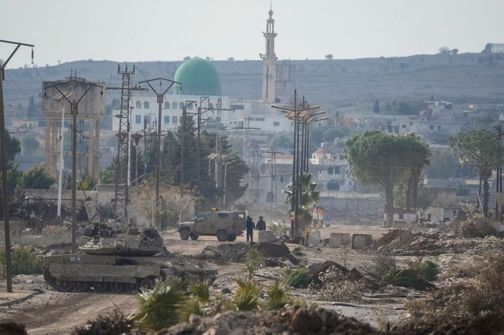 Israeli army armored vehicles block a road leading to the town of Quneitra, Syria
