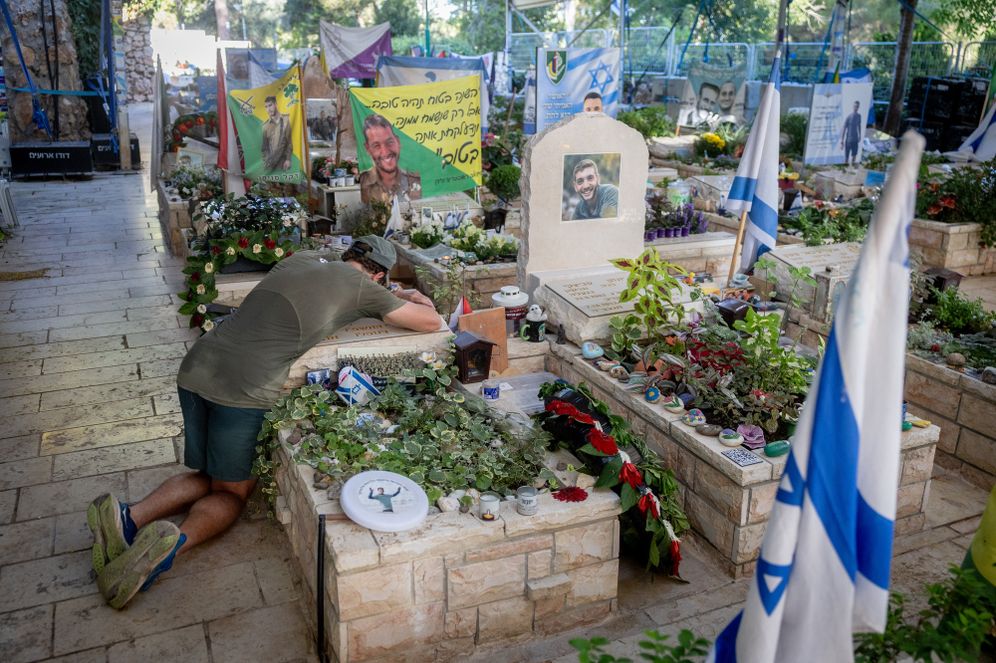 Photo by Chaim Goldberg/FLASH90 A man mourns at a grave in Mt Herzl, at the section with victims killed in the October 7 Hamas attack, October 07, 2026.