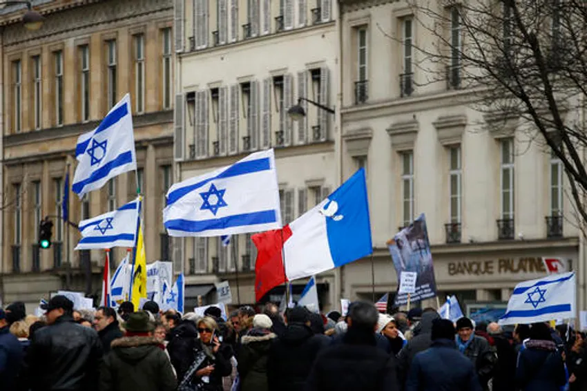 Pro-Israel demonstrators hold Isreali and France flags during a gathering in front of Israel embassy in Paris, France, Sunday, Jan. 15, 2017.