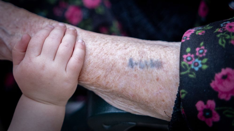 Holocaust survivor with a number on her arm, archive
