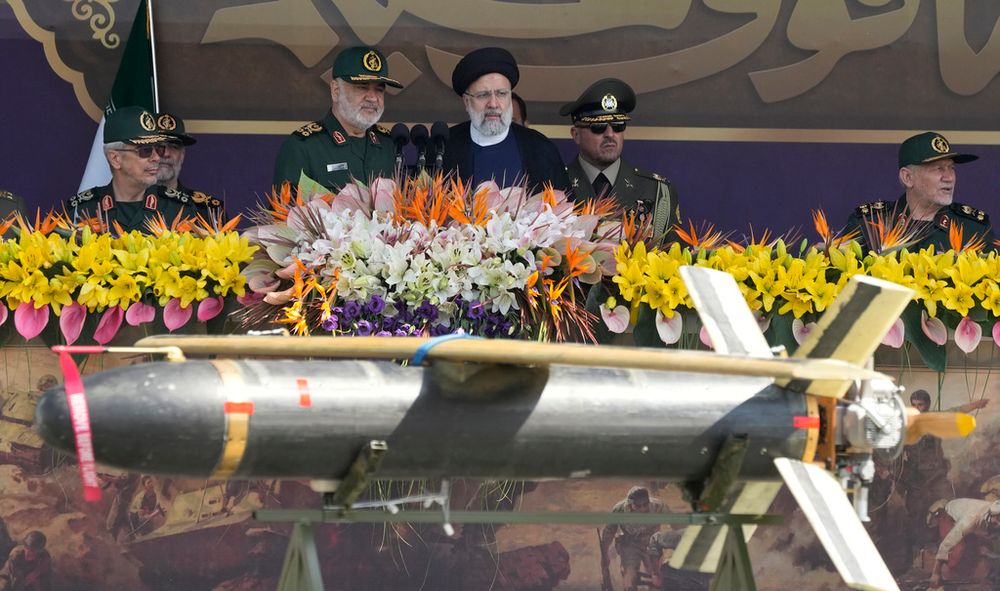 Iranian President Ebrahim Raisi (C) reviews a military parade in Tehran, Iran.