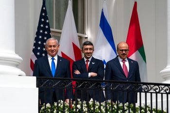 Israeli Prime Minister Benjamin Netanyahu, left, United Arab Emirates Foreign Minister Abdullah bin Zayed al-Nahyan, and Bahrain Foreign Minister Khalid bin Ahmed Al Khalifa stand on the Blue Room Balcony during the Abraham Accords signing ceremony on the South Lawn of the White House
