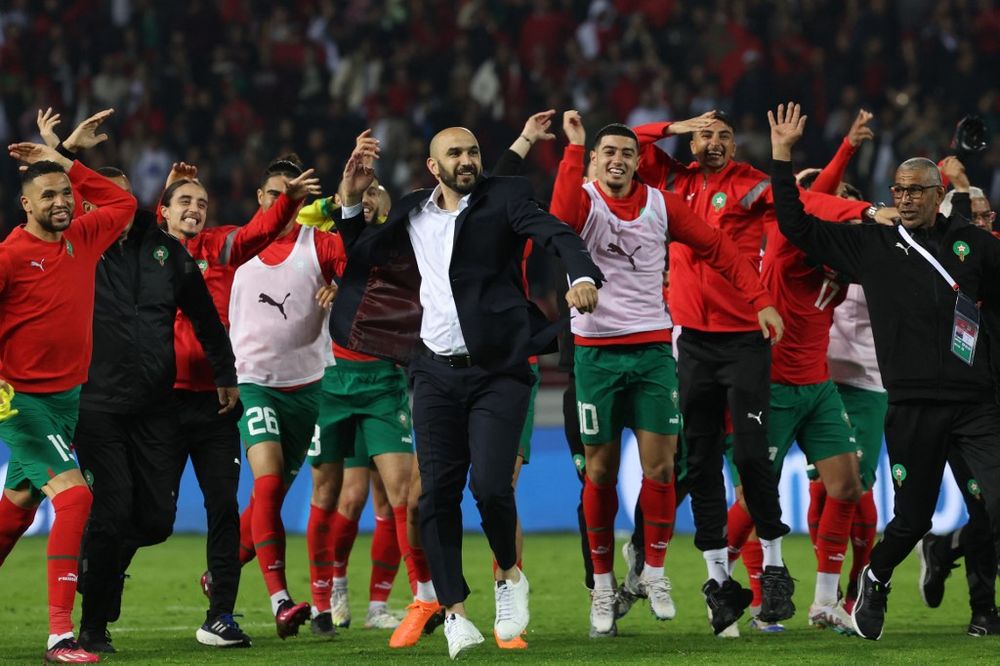 Morocco's coach Walid Regragui (C) and his players greet fans after the friendly football match between Morocco and Brazil at the Ibn Batouta Stadium in Tangier.