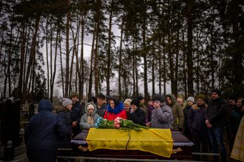 Civilians mourn during a funeral in Kalynivka, Ukraine.
