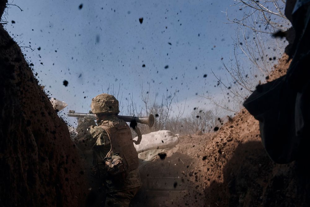 A Ukrainian soldier fires a grenade launcher on the frontline during a battle with Russian troops near Bakhmut, Donetsk region, Ukraine.
