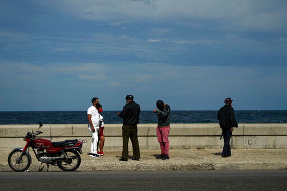 Three police officers speak with two people walking in Havana, Cuba, November 15, 2021.
