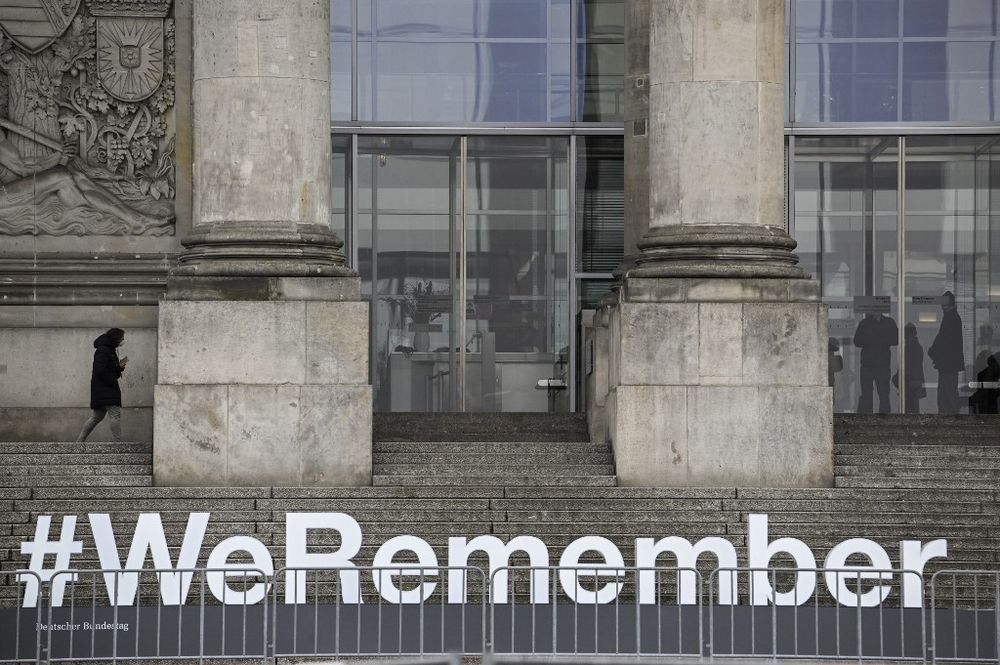 The lettering #WeRemember is seen on the stairs leading to the Reichstag building hosting the German lower House of parliament, the Bundestag, in Berlin as part of the ceremonies for the International Holocaust Remembrance Day held on January 27.