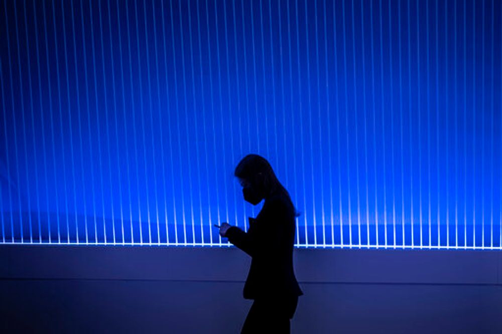 A woman walks past the Telefonica stand during the Mobile World Congress 2022 in Barcelona, Spain, on February 28, 2022.