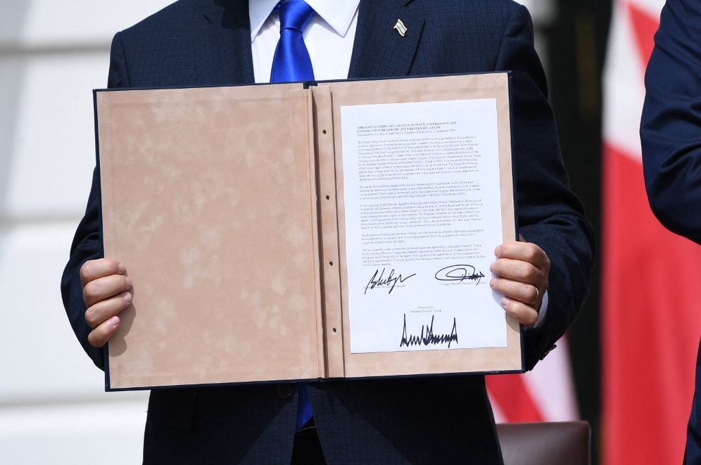 Israeli Prime Minister Benjamin Netanyahu holds up a document after participating in the signing of the Abraham Accords in Washington, the United States.