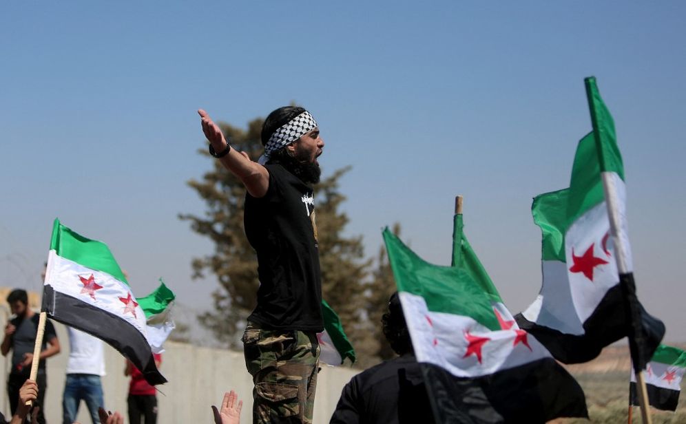 Syrians rally outside a Turkish army position in the opposition-held village of al-Mastumah, south of the city of Idlib, northwestern Syria, on August 12, 2022.
