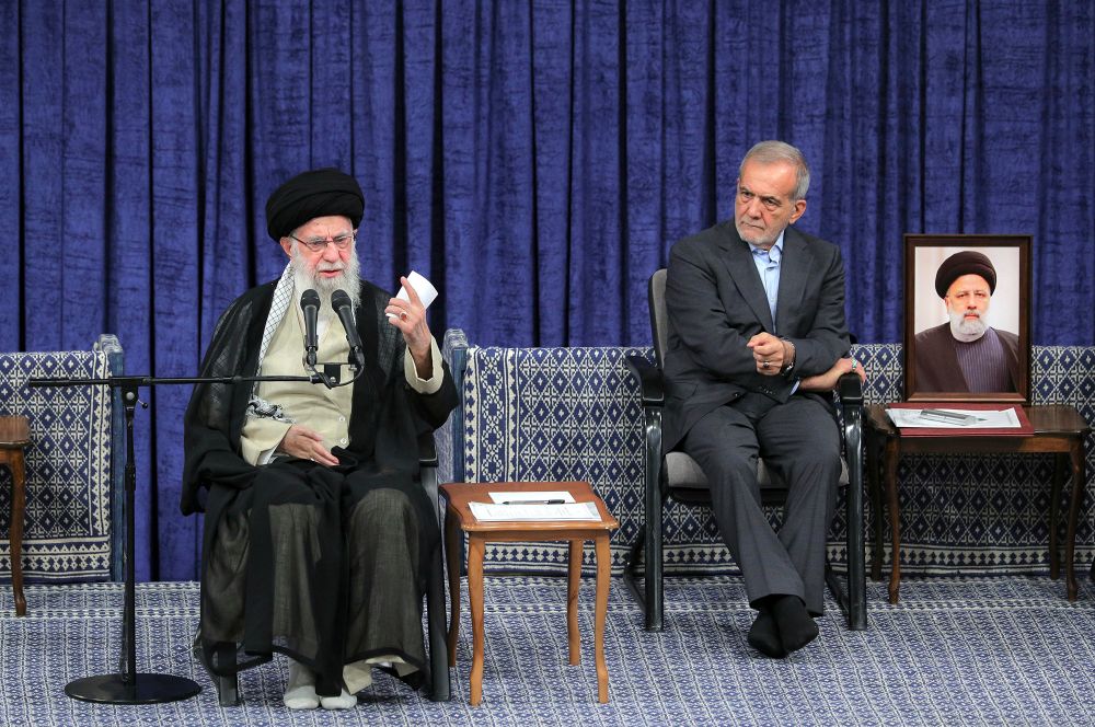 Iranian Supreme Leader Ayatollah Ali Khamenei (left) speaks after giving his official seal of approval to newly elected President Masoud Pezeshkian