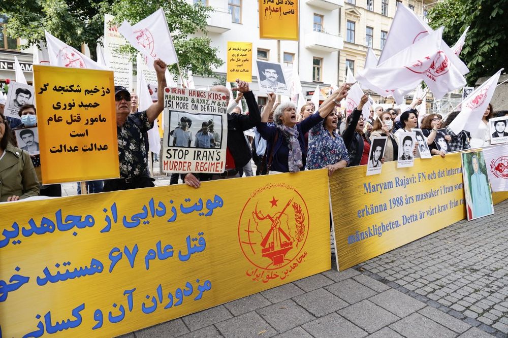Supporters of the People's Mojahedin of Iran Organization protest outside Stockholm's district court in Sweden, on August 10, 2021, on the first day of the trial of an Iranian man.