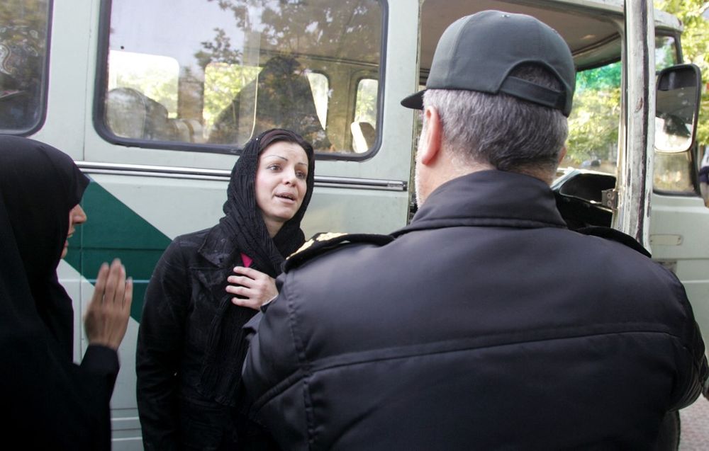 A file photo showing a woman being arrested by Iran's morality police.