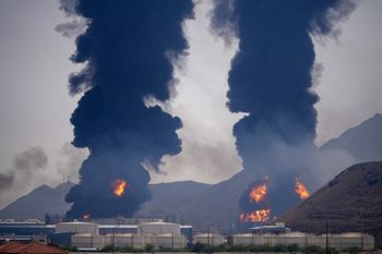 (AP Photo/Altaf Qadri, File) FILE - Plumes of smoke and fire rise after debris from an intercepted Iranian drone struck an oil facility, according to authorities, in Fujairah, UAE, March 14, 2026