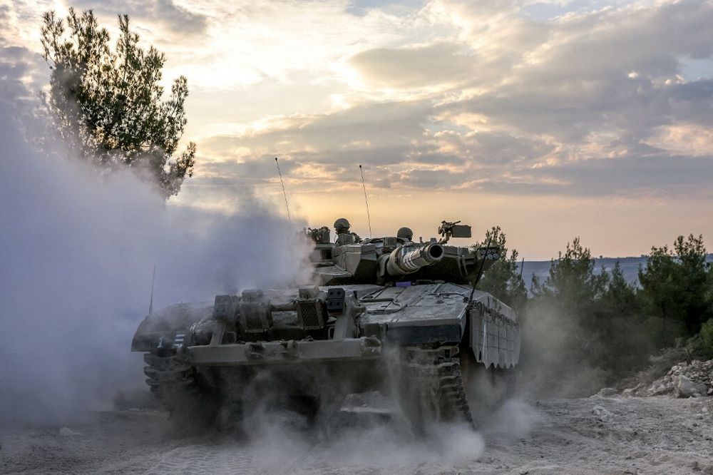 An Israeli army battle tank moves at a position in the upper Galilee region of northern Israel near the border with Lebanon on November 1, 2023