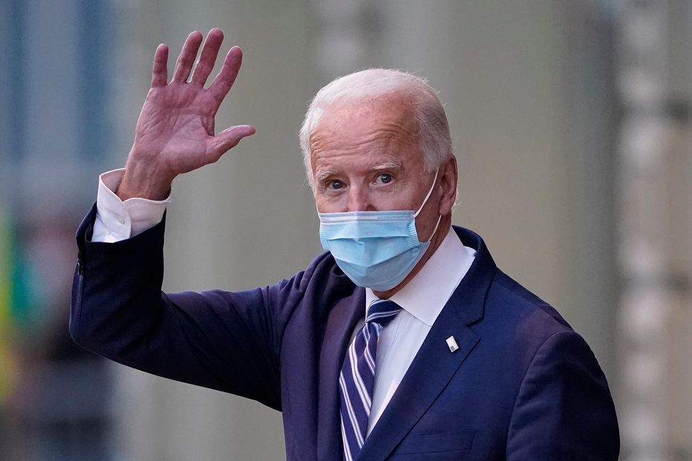 Presumptive US President-elect Joe Biden waves as he leaves The Queen theater, on November 10, 2020, in Wilmington, Delaware.