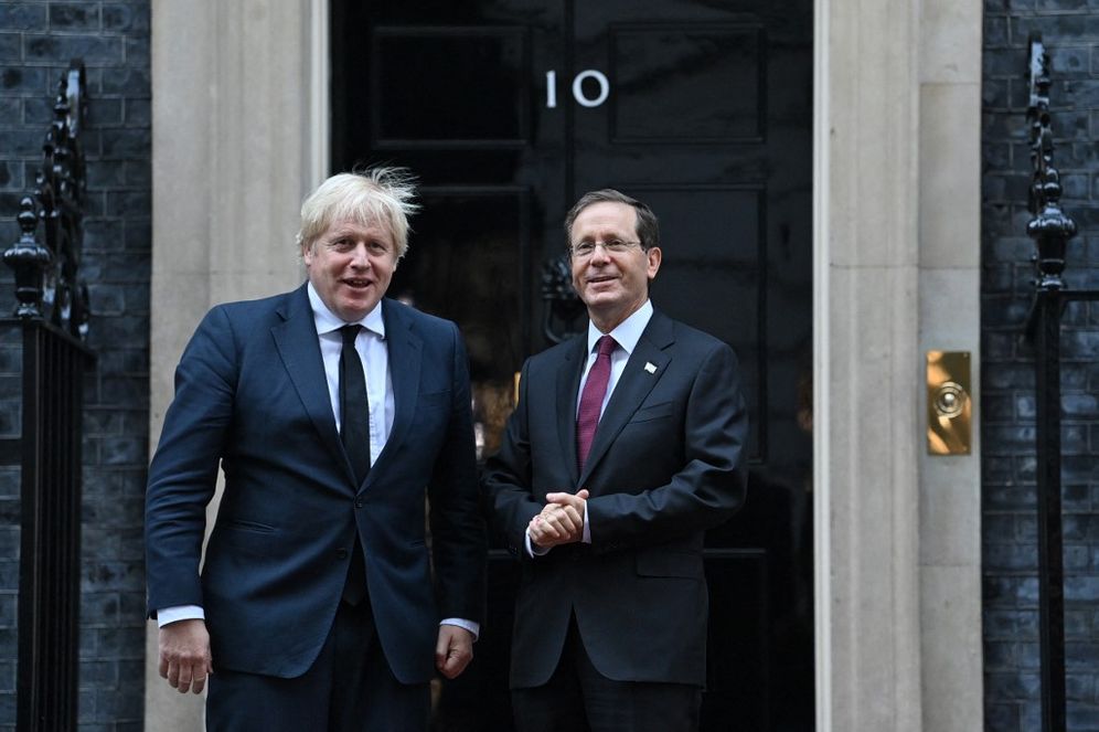 Israeli President Isaac Herzog (R) meets with British Prime Minister Boris Johnson outside of the prime minister's official residence Number 10 Downing Street in central London, England, on November 23, 2021.