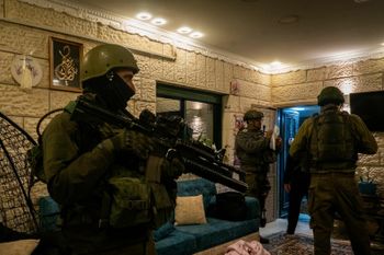 Israeli soldiers conduct a raid in the West Bank
