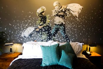 A Banksy wall painting showing an Israeli border police officer and a Palestinian in a pillow fight in The Walled Off Hotel in the West Bank city of Bethlehem, on March 3, 2017.
