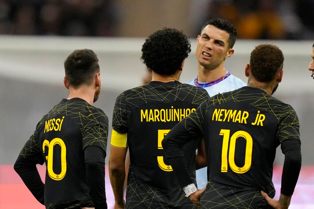 Cristiano Ronaldo (Blue) flanked by PSG's Lionel Messi (L) and his teammates Neymar (R) and Marquinhos during a friendly soccer match in Riyadh, Saudi Arabia, on January 19, 2023.