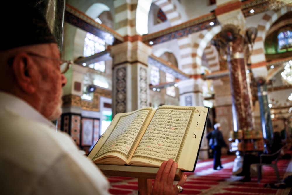 A muslim man reads the Koran in a mosque in Jerusalem's Old City, on October 06, 2018.