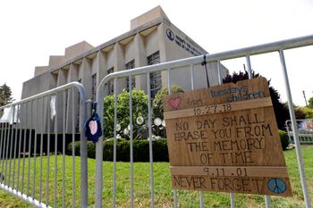 A sign hangs on a fence surrounding the Tree of Life synagogue in Pittsburgh, Pennsylvania.