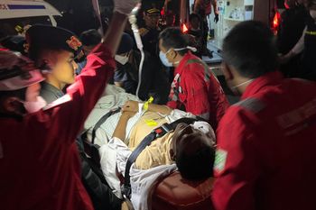 (AP Photo/Iman Satria) In this photo taken with a smartphone, rescuers wheels a survivor of a sinking ferry on a stretcher upon arrival at a port in Banjarmasin, South Kalimantan, Indonesia, Sunday, Sept. 13, 2026.