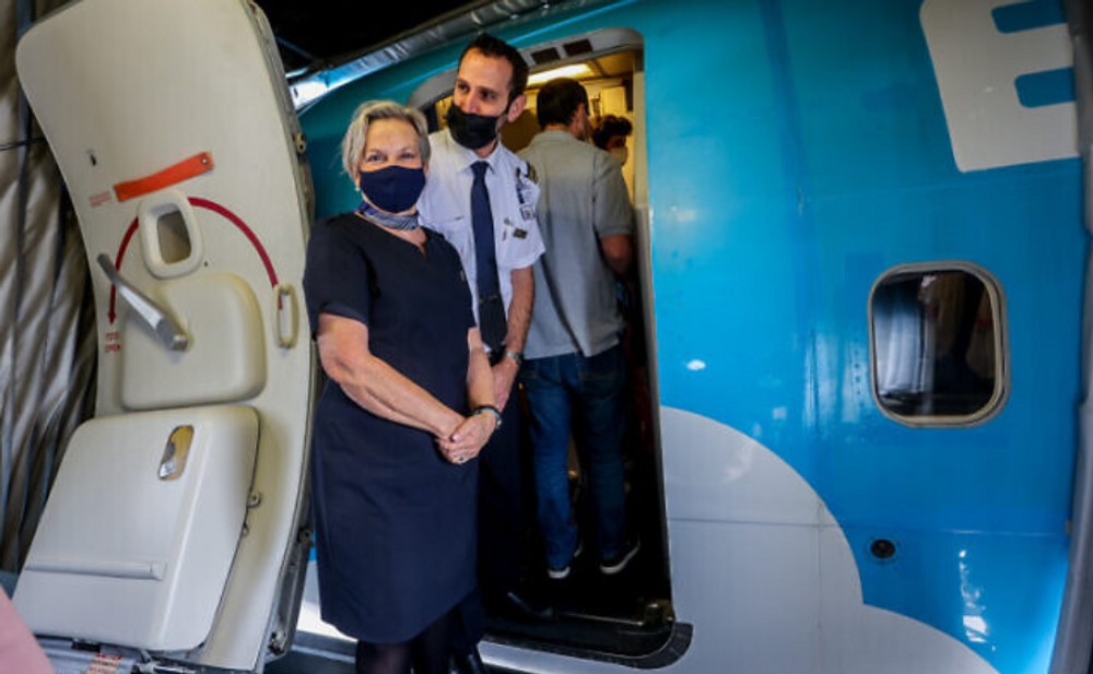 Crew members wearing face masks stand at the gate of the first direct flight from Tel Aviv to Egypt's Red Sea resort of Sharm el-Sheikh at Ben Gurion Airport near Tel Aviv on 17 April 2022.