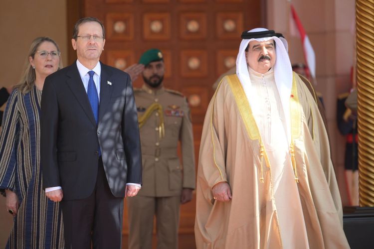 L-R: Israel's First Lady Michal Herzog, Israel's President Isaac Herzog and Bahrain's King Hamad bin Isa Al Khalifa at Al-Qudaibiya Palace in Manama, Bahrain, December 4, 2022.