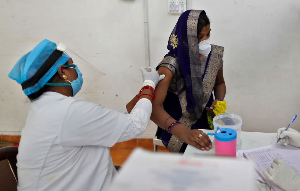 A woman receives the AstraZeneca vaccine for COVID-19 at a hospital in Prayagraj, India, May 1, 2021.