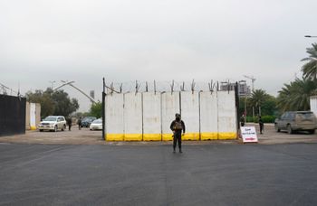Iraqi security forces stand guard as they check motorists entering the Green Zone, in Baghdad, Iraq.