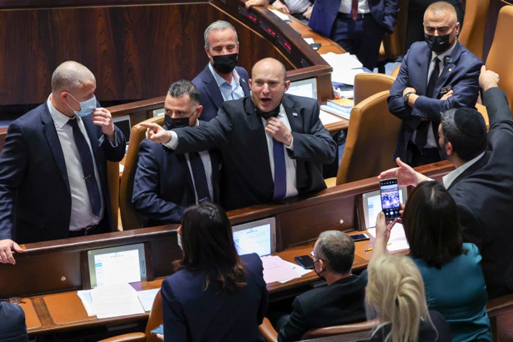 Israel's Prime Minister Naftali Bennett confronts opposition members during a plenum session and a vote on an electricity bill at Israel's parliament, Jerusalem, January 5, 2022.