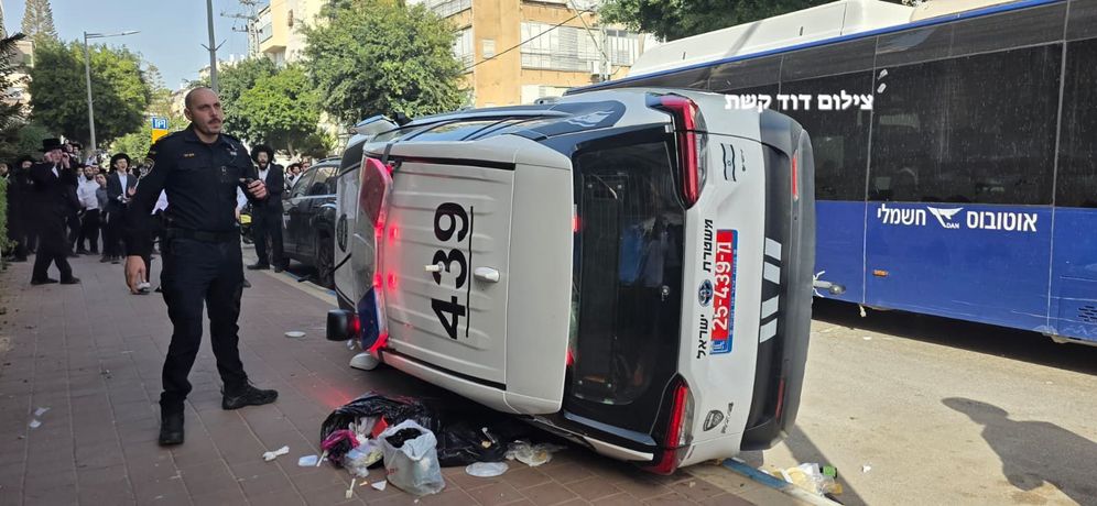 A police car overturned in Bnei Brak after rescuing two female soldiers from the scene.
