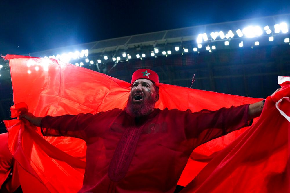A fan of Morocco displays the country's flag in Al Khor, Qatar.