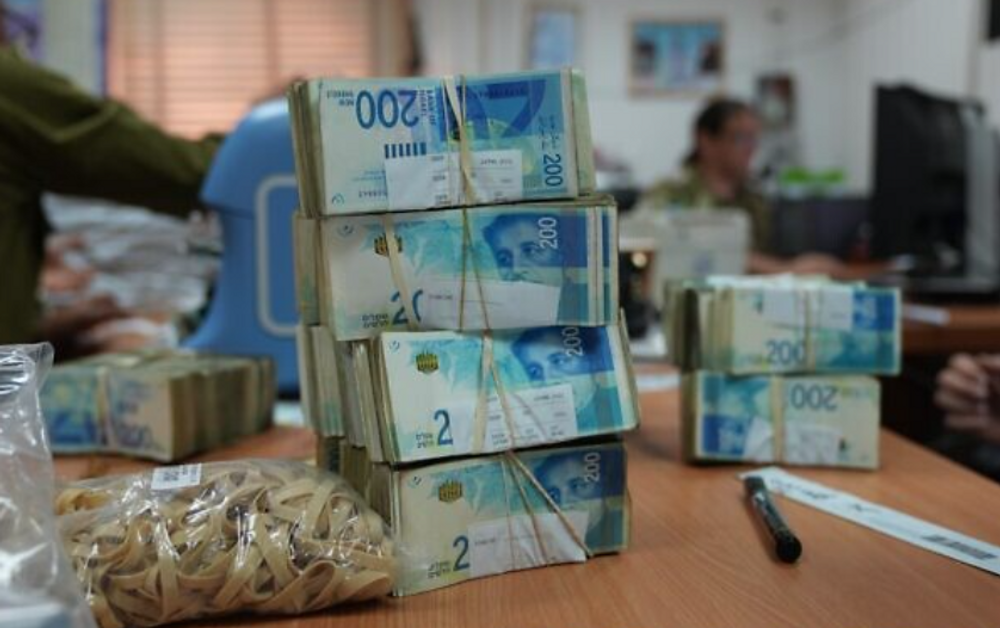 A file photo of Israeli currency in Gaza 