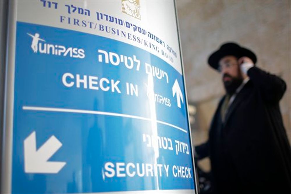 A passenger waits in line next to the new biometrics identification system to go through the security check in Ben Gurion airport near Tel Aviv, Israel, Jan. 5, 2010.