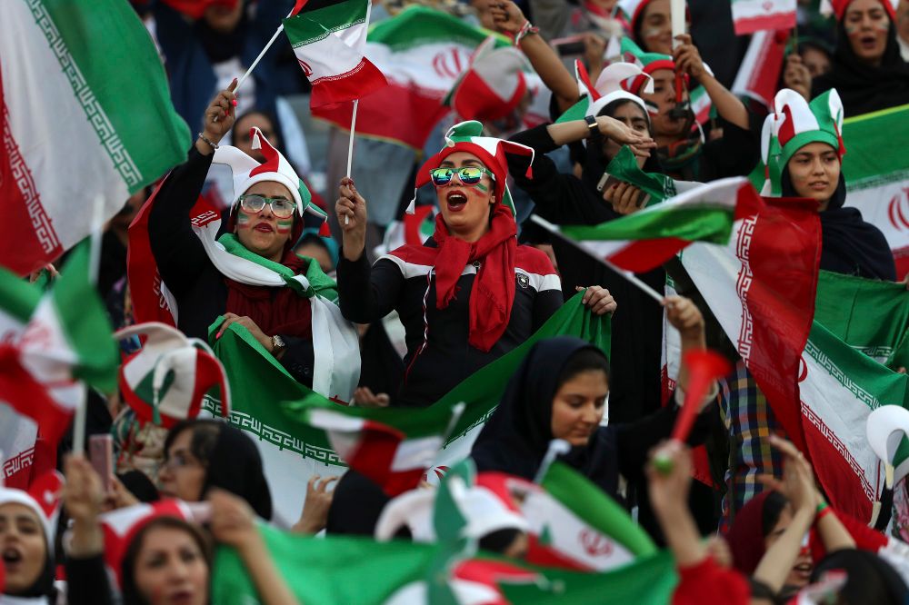 Iranian women cheer during a soccer match between their national team and Cambodia in the 2022 World Cup qualifier at the Azadi (Freedom) Stadium in Tehran, Iran, October 10, 2019.