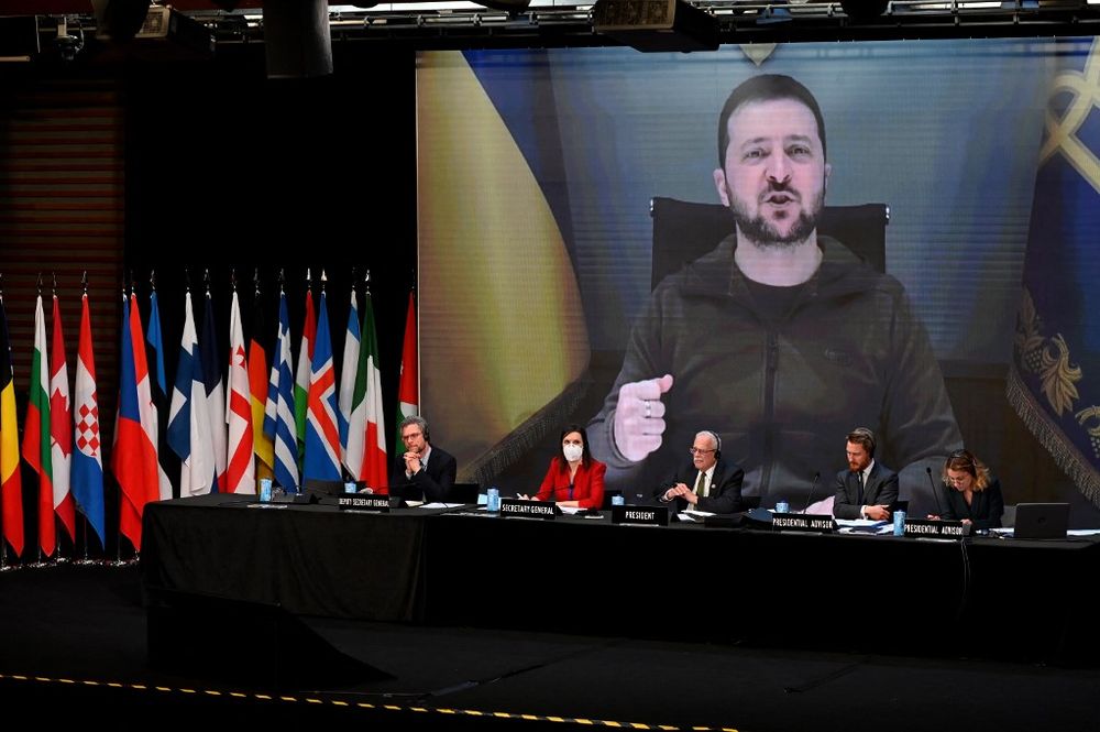 Le président ukrainien Volodymyr Zelensky sur un écran géant alors qu'il prononce un discours lors de la session annuelle de l'Assemblée parlementaire de l'OTAN à Madrid le 21 novembre 2022.