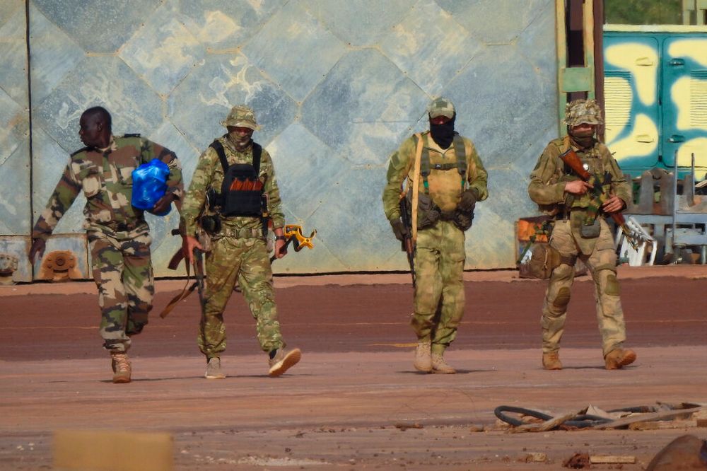 This undated photograph shows three Russian mercenaries (R) in northern Mali.