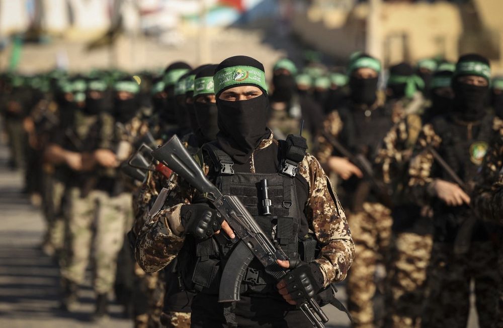 Masked members of the al-Qassam Brigades, the military wing of Hamas, march during a rally in Gaza City, Gaza, on July 20, 2022.