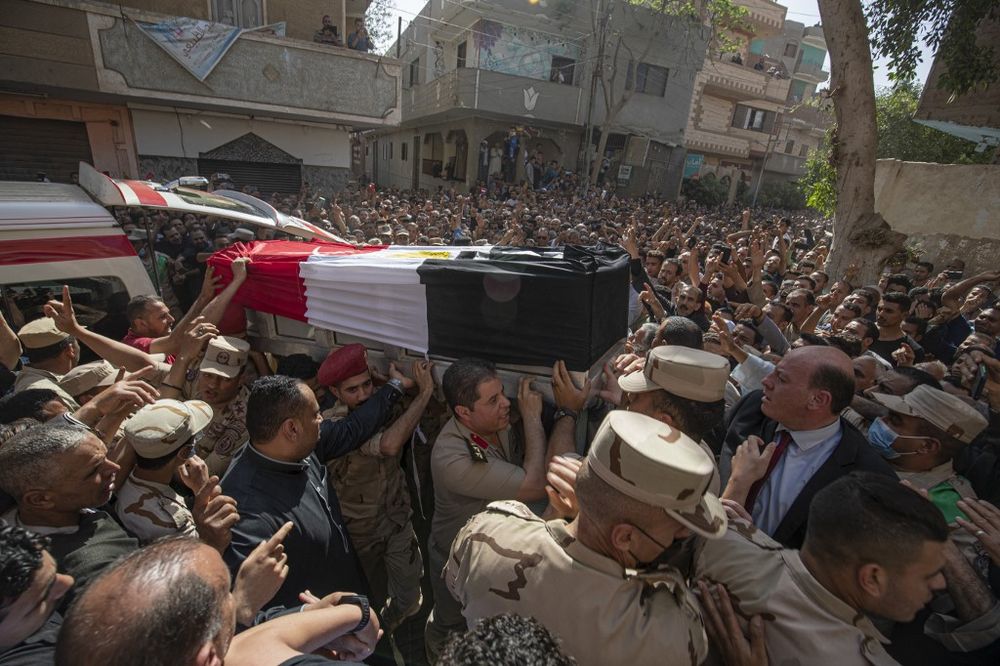 Mourners and soldiers carry the casket of Egyptian First Lieutenant Soleman Ali Soleman, one of 11 soldiers killed in an attack claimed by the Islamic State group in the Sinai Peninsula, Jazirat al-Ahrar, May 9, 2022.