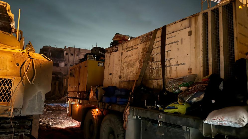 Trucks outside the Kamel Adwan Hospital in Gaza