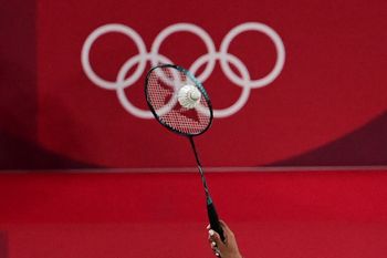Egypt's Doha Hany hits a shot next to the Olympics rings logo to China's Chen Yufei in their women's singles badminton group stage match during the Tokyo 2020 Olympic Games at the Musashino Forest Sports Plaza in Tokyo, Japan on July 25, 2021.