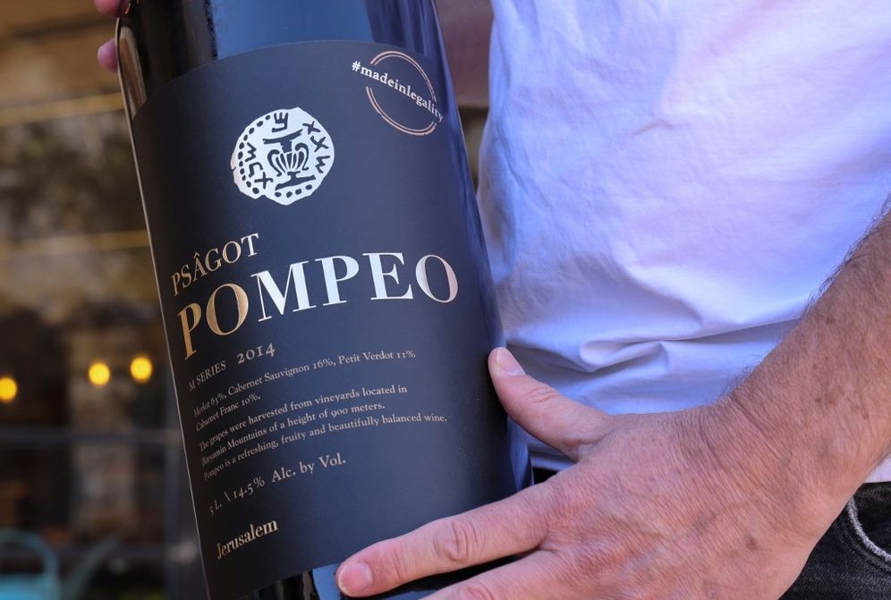 Israeli winemaker Yaakov Berg holds a bottle of his red blend named after US Secretary of State Mike Pompeo at the Psagot Winer near the Israeli Psagot settlement in the West Bank north of Jerusalem on November 18, 2020.