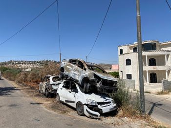 Torched cars stacked in aftermath of settler violence in the West Bank.
