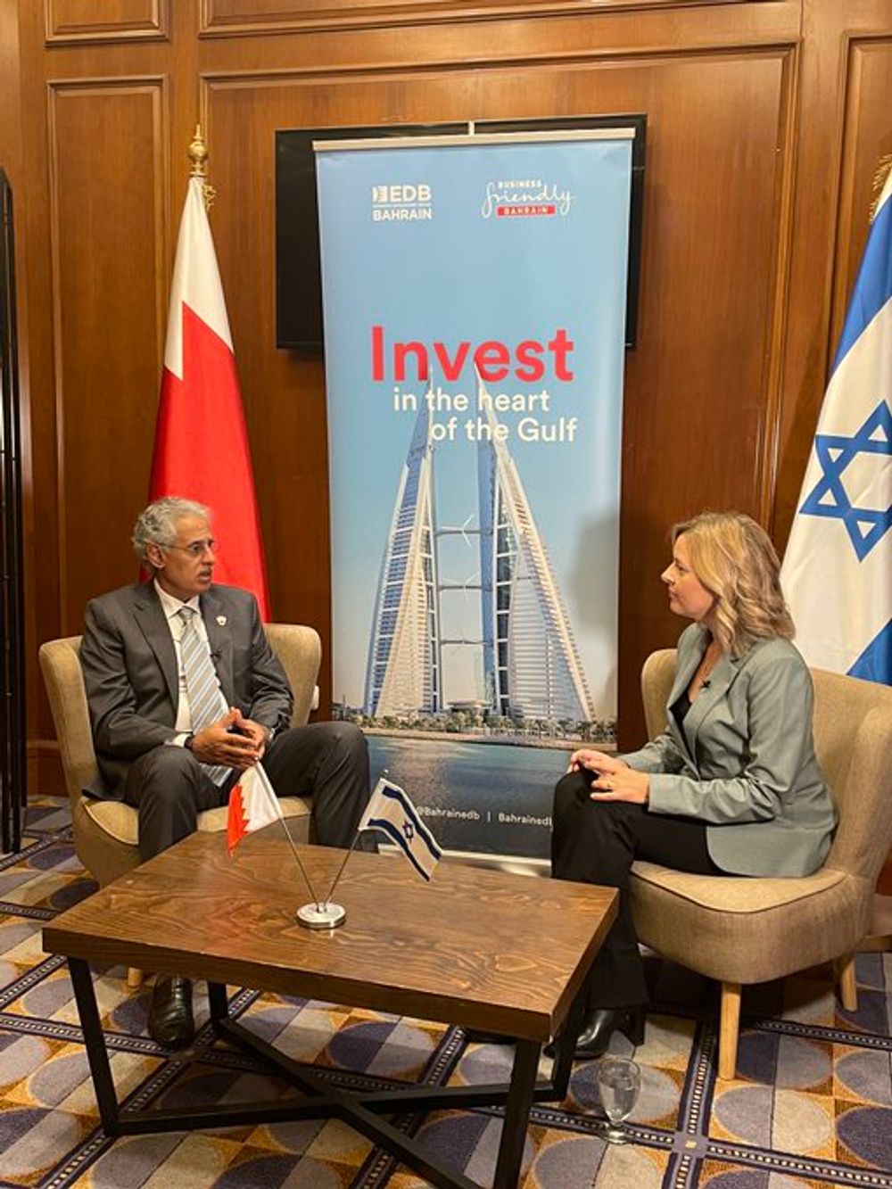 Bahrain's Minister of Industry and Commerce Zayed bin Rashid Al Zayani (L) speaks to i24NEWS' Laura Cellier on October 31, 2022.