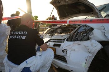 Israel Police examining the wreck of a car involved ina  ramming attack in the West Bank.